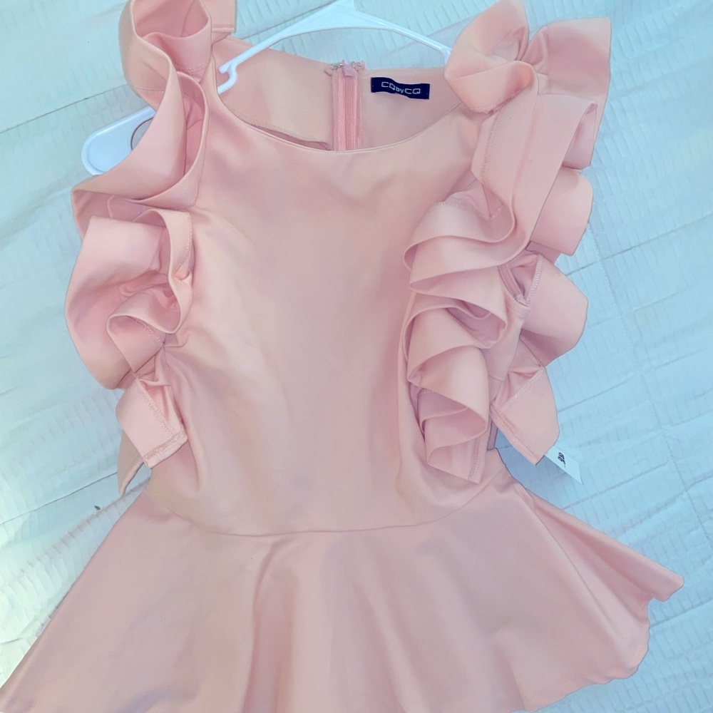 Ruffle shoulder peplum top. Light pink by CQ, size medium,